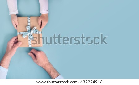 Son gives a gift to dad. Father's Day. Royalty-Free Stock Photo #632224916