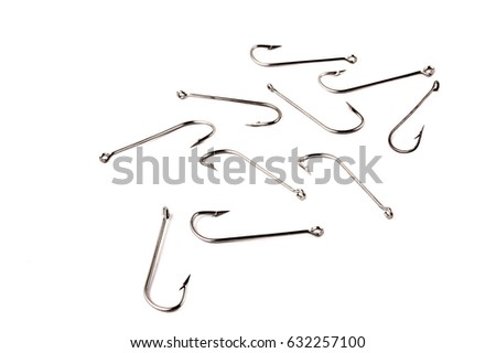 Fishing hooks isolated on white background. Several metallic stainless hooks lie randomly on the background