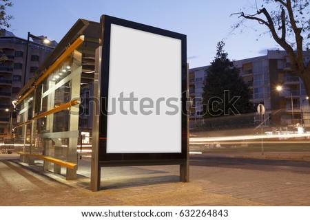 Blank advertisement in a bus stop, with blurred traffic lights