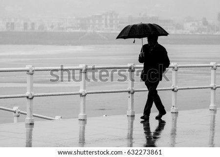 Man with umbrella walking around the city