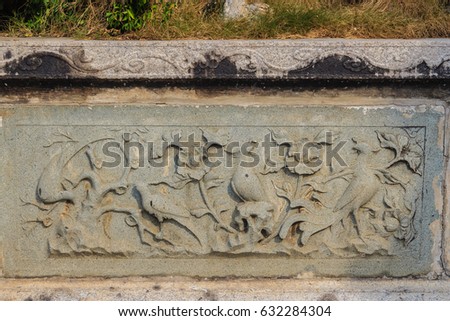 Beautiful background with flowers carving on the old stone.