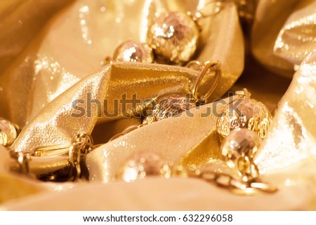 gold beads on bright brocade glare and sparks