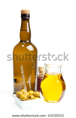 Appetizer of green olives and olive oil with bottle of wine