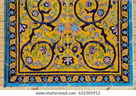 Colorful yellow islamic floral decoration art mosaic on a mosque wall in Qom, Iran