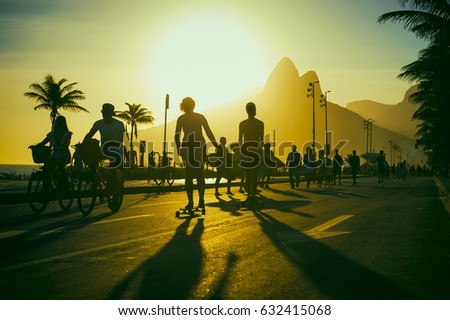 Scenic summer sunset silhouettes on the Ipanema beachfront road in Rio de Janeiro, Brazil