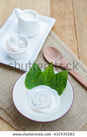 Coconut jelly coconut milk in cup on wood background local dessert thailand.