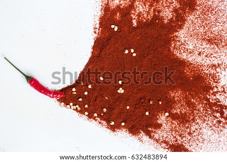 red hot chili peppers, popular spices concept - artistic idea of red hot pepper pod turns into a picture from powder of dry pepper, embodiment of abstract artist brush on white background