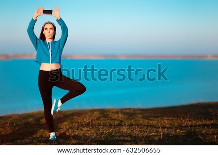 Girl in Yoga Pose Taking a Selfie Outside in Nature - Funny woman posing for her social media profile in a sporty outfit

