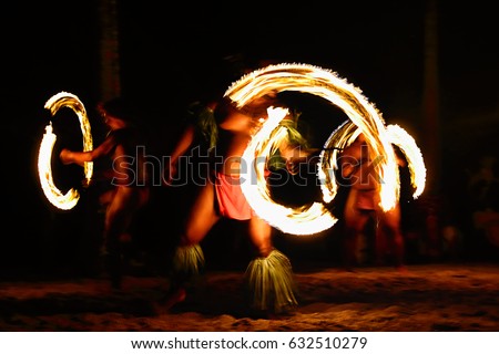 Fire dancers at Hawaii luau show, polynesian hula dance men juggling with fire torches. Royalty-Free Stock Photo #632510279