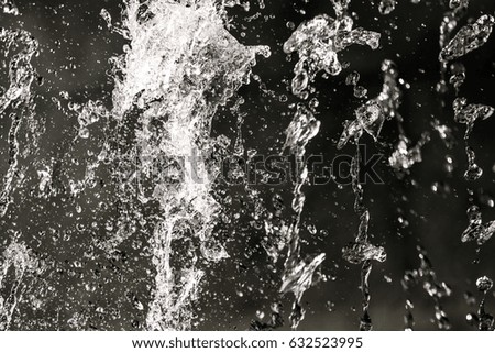 Jets and splashes of water on a black background