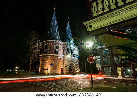 Ancient city gate in the historic city of Kampen, at the river IJssel in the province of Overijssel in the Netherlands. Photo  during night photography with long shutter speed in the city park. 