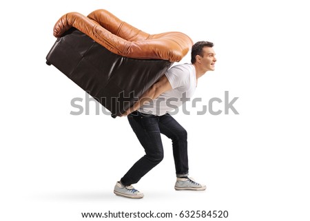 Profile shot of a young guy carrying an armchair on his back isolated on white background Royalty-Free Stock Photo #632584520