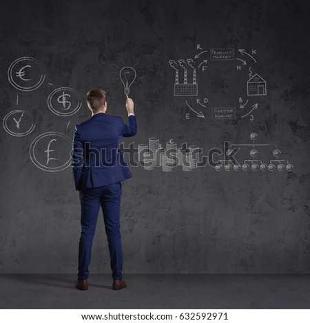 Businessman standing and drawing schemes. Business and office, concept.