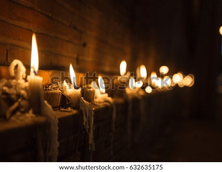 candle lights around brick wall