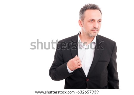 Picture of young casual man posing and looking one side on white background with copyspace
