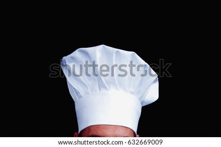 Chefs hat against black background Royalty-Free Stock Photo #632669009
