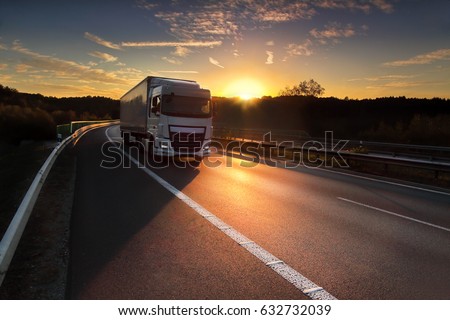 Truck transportation at sunset Royalty-Free Stock Photo #632732039
