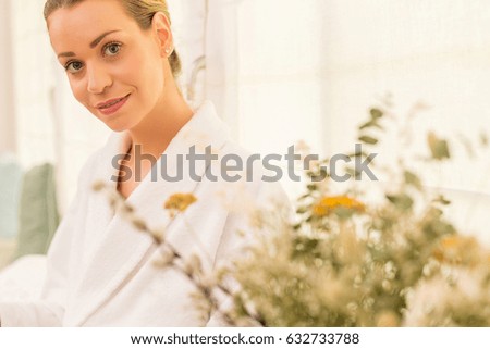 woman in bathrobe on light background