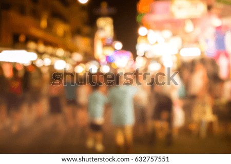 Blurred image of busy night life in the city. Defocused photo of night lights of the famous Ko San Road in Bangkok, Thailand.