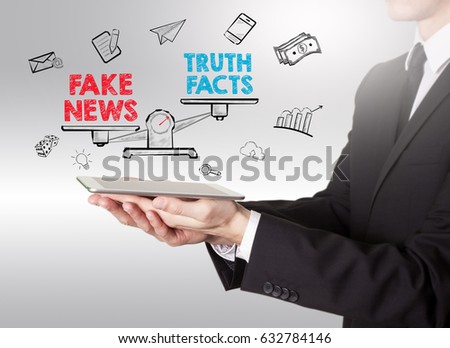 Fake News Infomation concept. Young man holding a tablet computer