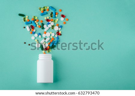 Various medications and vitamins, a pill bottle. Pastel background, place to insert your text. Health and pharmacy. Royalty-Free Stock Photo #632793470