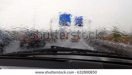 gloomy weather background. Traffic jam and stormy weather. Rain streams on the windscreen