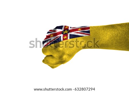 Fist painted in color Niue flag, hand isolated on white background.
