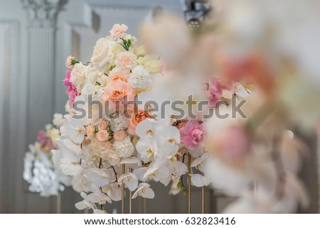 Blurred picture of colorful bouquets on dinner table