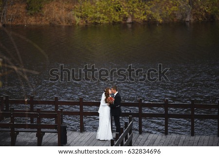 Wedding day, love couple posing on camera at photo session. The groom and wife. Wedding dress of bride and veil