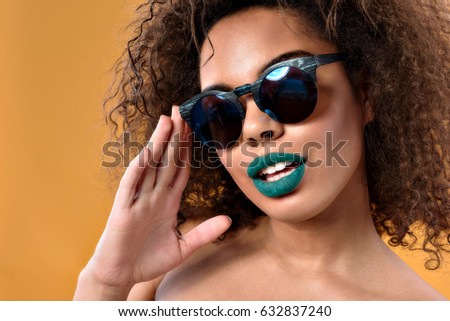 Trendy ethnic female looking at camera