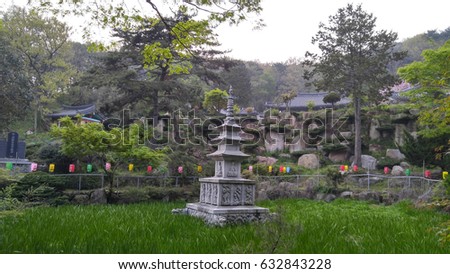 Stone pagoda on the background of green trees