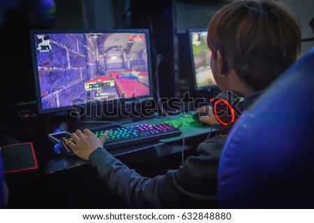 young man playing computer games on line