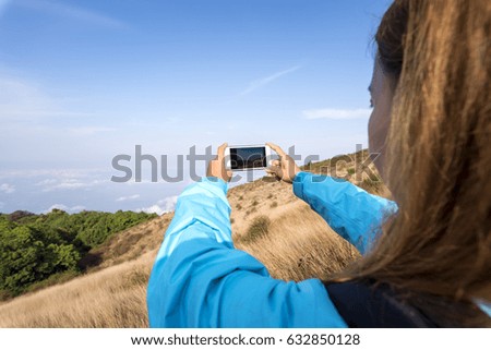 traveler use smartphone take a picture mountain landscape view