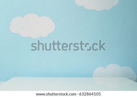 sky blue wall and an empty table. Royalty-Free Stock Photo #632864105