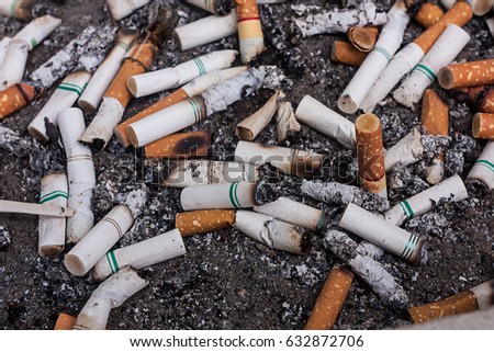 selective focus of  burned cigarette in ashtray,abstract background for no smoking in city and World No Tobacco Day concept.