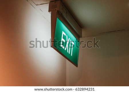 Exit sign points the way out of building at the Hotel