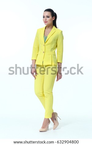 Indian woman with pony tail in summer yellow pant suit full body length high heeled shoes back shot isolated on white