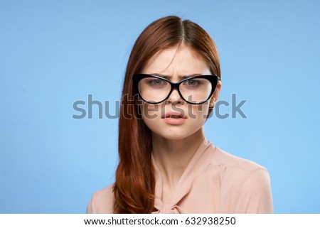  Sad woman with glasses on blue background                              