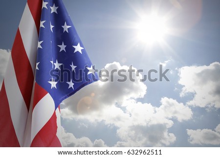 American flag in front of sunny sky