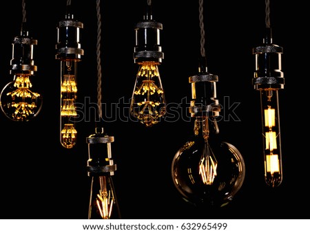 several different led Edison bulbs on black background