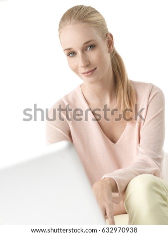 Shot of a beautiful young woman using her laptop while sitting at isolated white background with copy space. 
