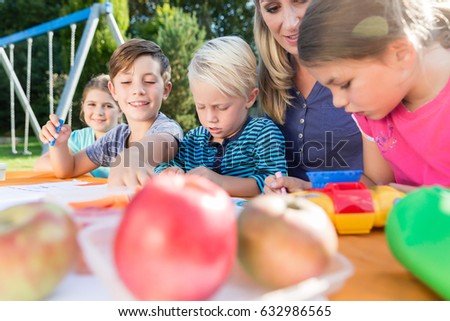 Mum painting pictures with their children and during lunch break 