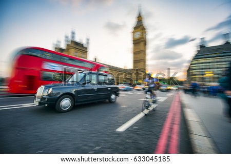 Motion blur zoom effect view of traffic passing on the street in front of Big Ben in London, England