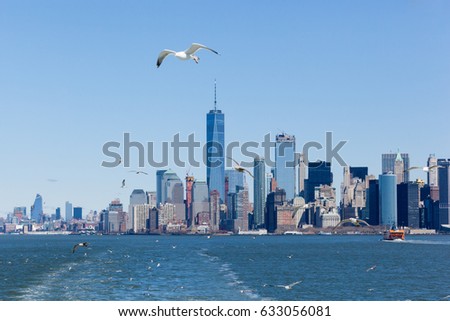 The Lower Manhattan Skyline with Freedom Tower, is seen from the Hudson River. A Staten Island Ferry travels toward Whitehall Terminal in the picture.