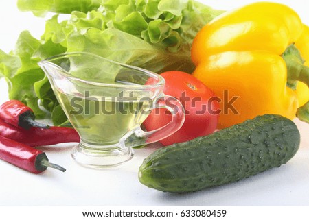 Assorted vegetables, fresh bell pepper, tomato, chilli pepper, cucumber, olive oil and lettuce isolated on white background. Selective focus.