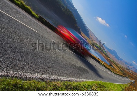 mountain road with blurred car