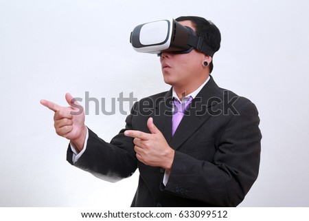 Technology, gaming, entertainment and people concept. business man wearing formal suit and virtual reality headset or 3d glasses, playing video game, gesturing with his hands and catching something.