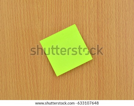 green  note paper and wood  background 