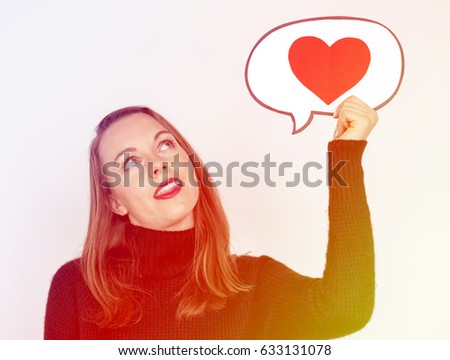 Woman holding love heart speech bubble