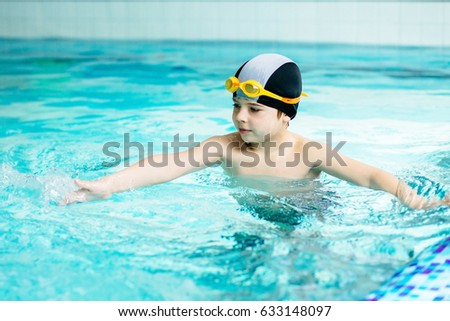 boy with yellow goggles at the pool at the leisure center Royalty-Free Stock Photo #633148097